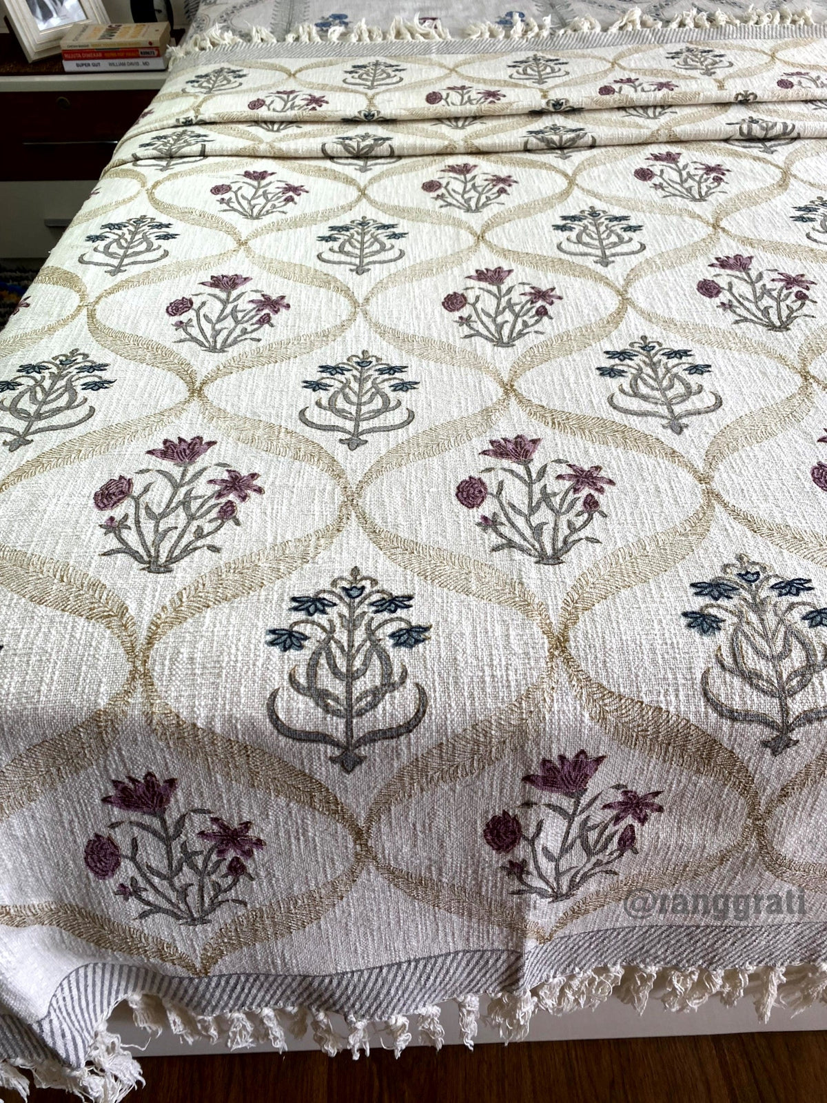 Blue And Pink Floral Jute Cotton Sofa Throw - front view on bed
