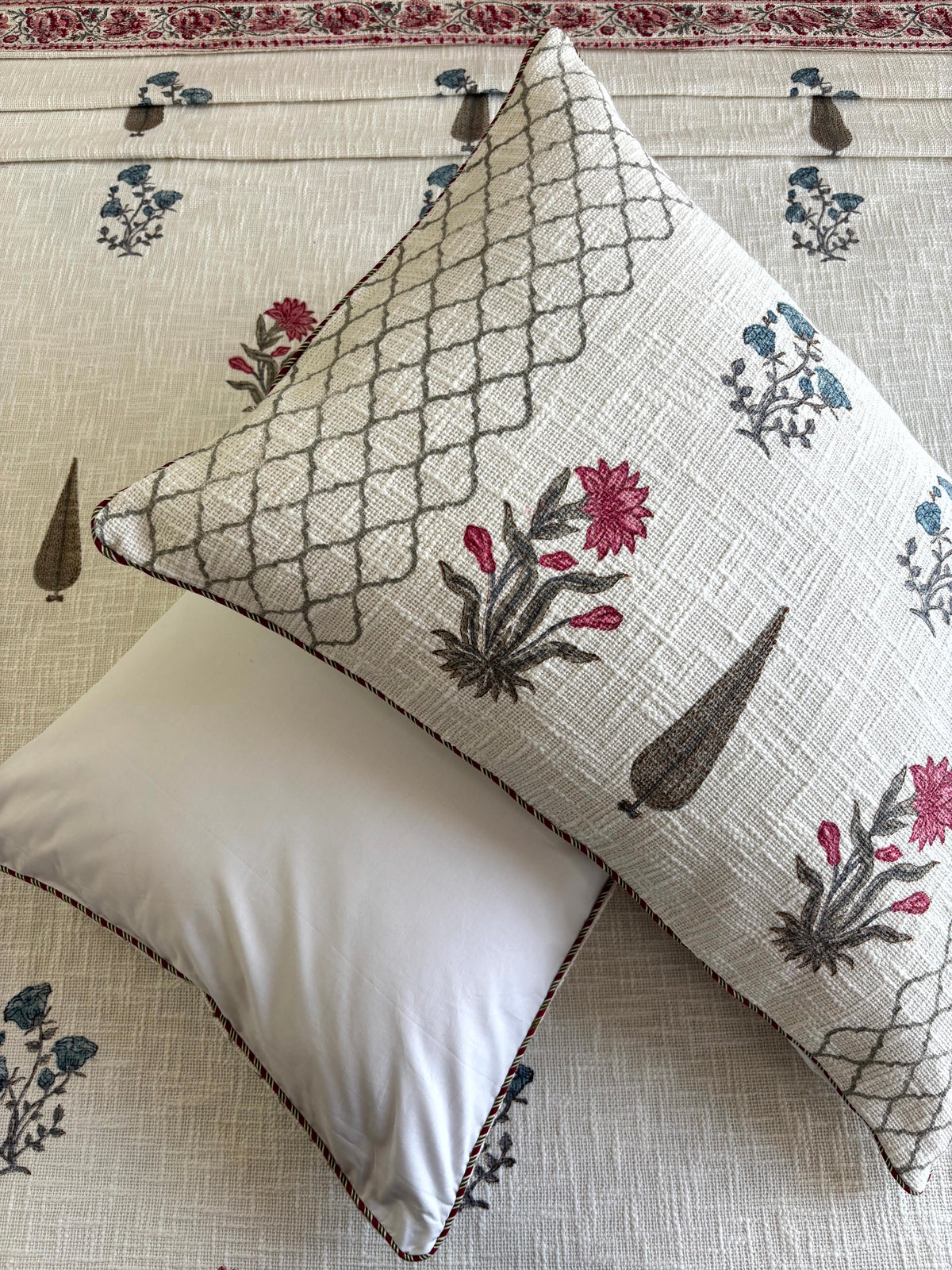 Matching hand block printed pillow covers with pink and blue floral motifs from the Gulistan Whisper bedcover set.