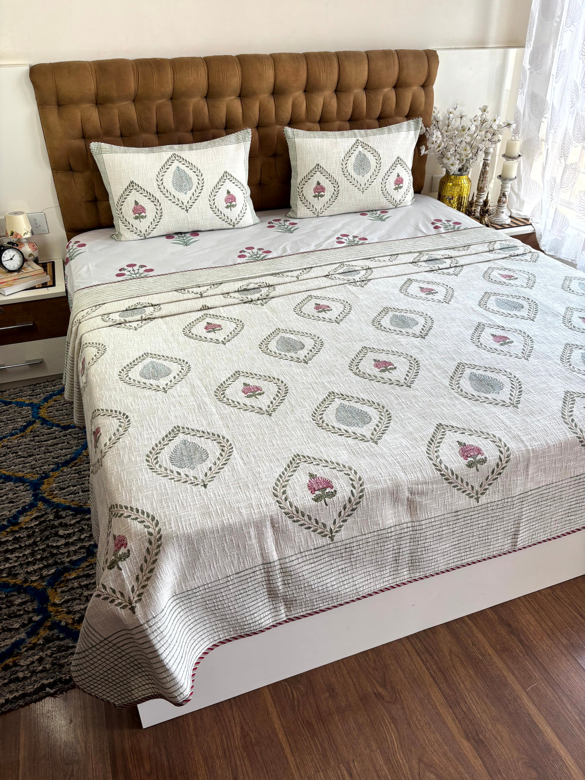 Padma Vana ivory jute cotton king size bedcover with hand block printed lotus floral motifs and matching pillow covers.