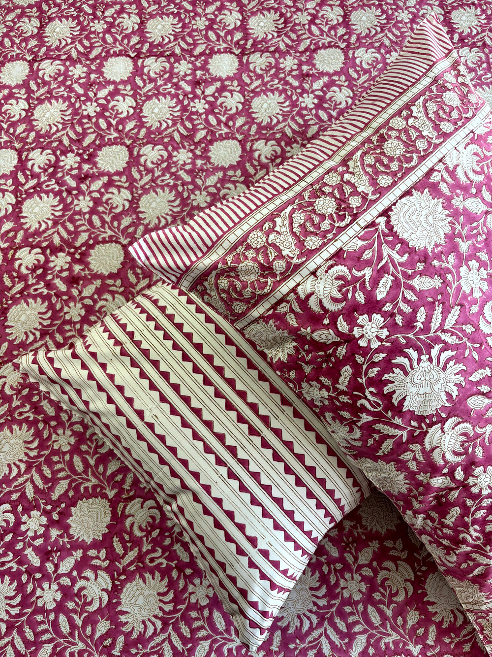 Jaipur hand block printed rose pink floral bedsheet spread on a super king bed