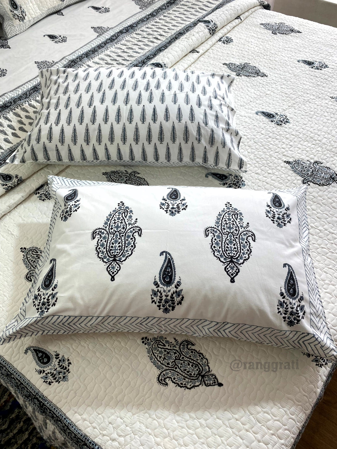 Pillows with paisley pattern on a matching quilt