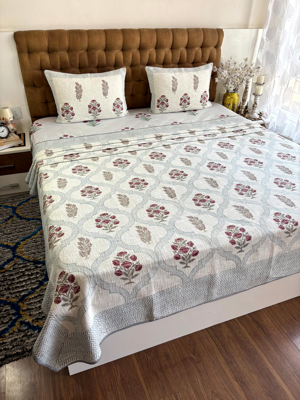 Gul-e-Meher ivory jute cotton king size bedcover with rose floral hand block print and matching pillow covers.