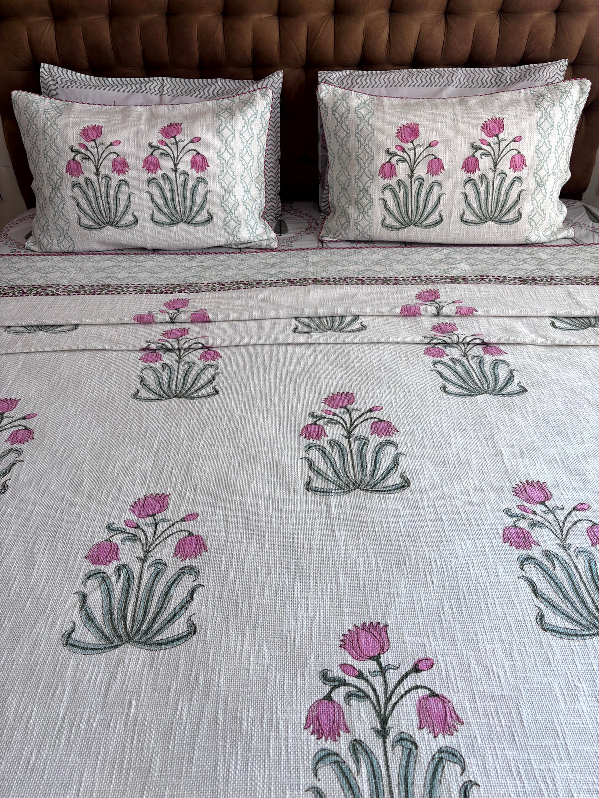 Gulmohar Melody hand block printed king size jute cotton bedcover styled in a bright modern bedroom.
