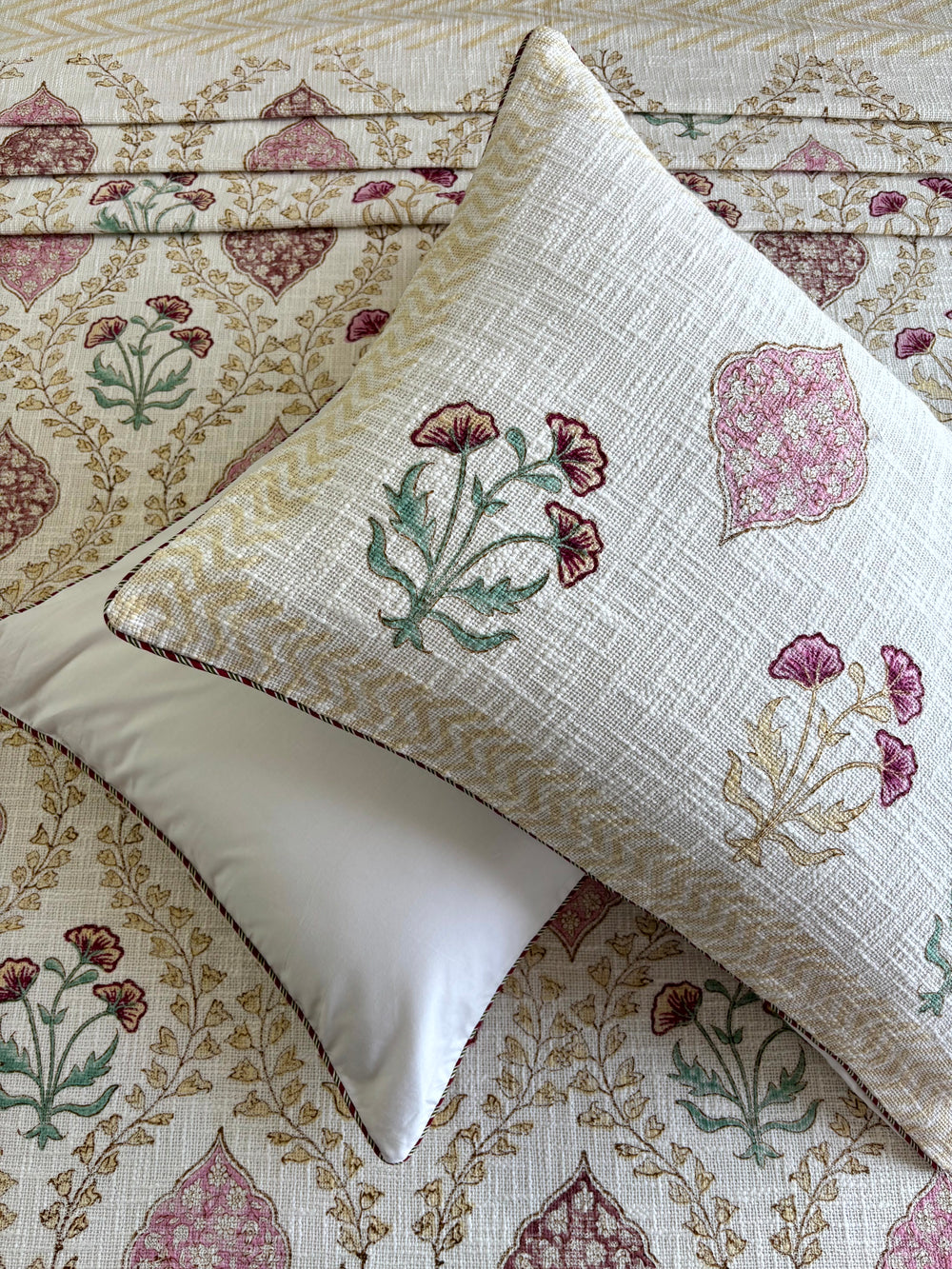 Gulnaar Jaal ivory hand block printed jute cotton king size bedcover with blush pink floral jaal design and matching pillow covers.

