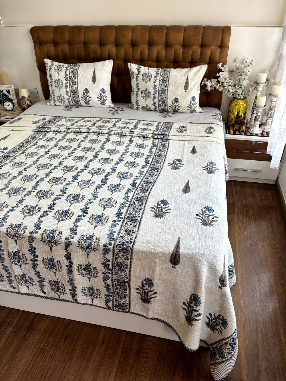 Premium Neel Pushp Symphony hand block printed ivory jute cotton king size bedcover adding timeless Jaipuri elegance to bedroom décor.
