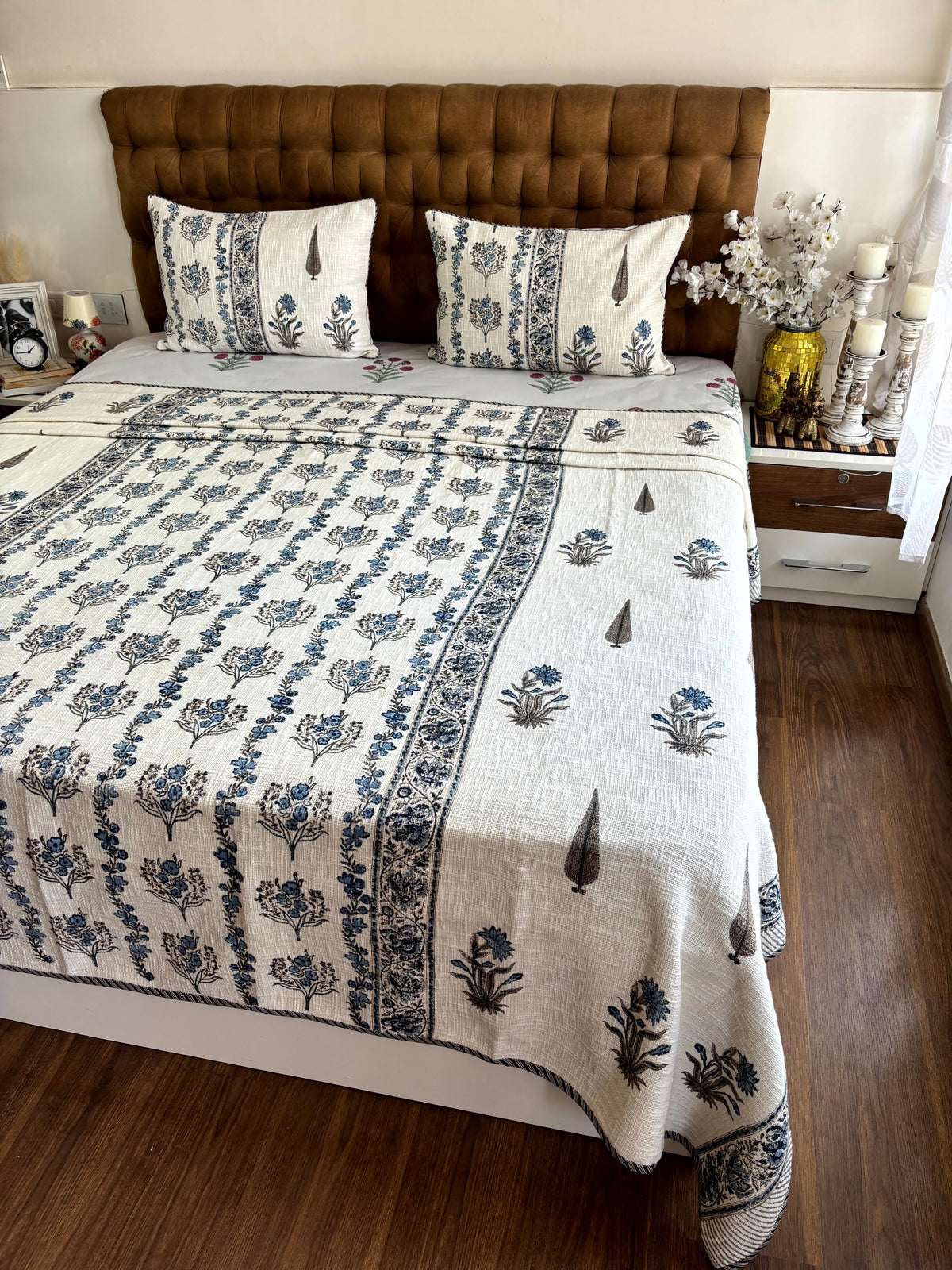Premium Neel Pushp Symphony hand block printed ivory jute cotton king size bedcover adding timeless Jaipuri elegance to bedroom décor.