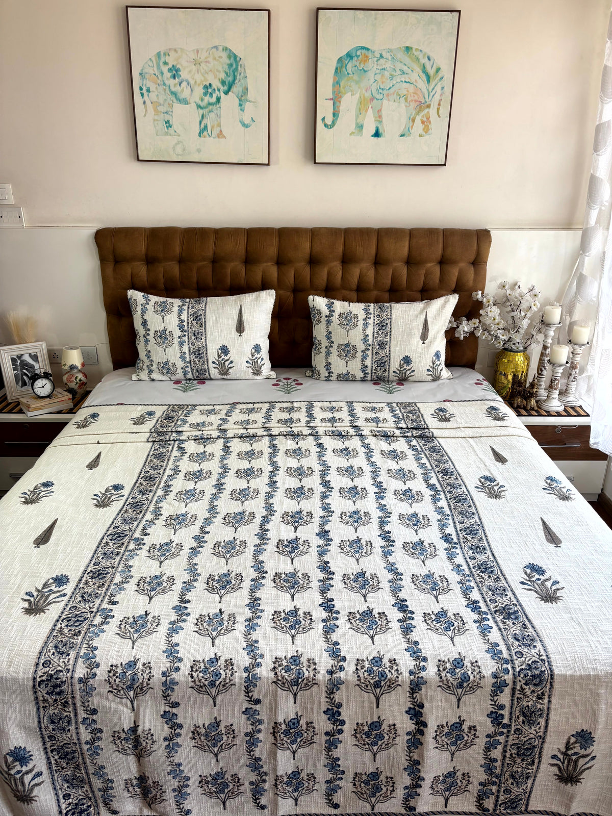 Neel Pushp Symphony hand block printed king size jute cotton bedcover styled in an elegant modern bedroom.
