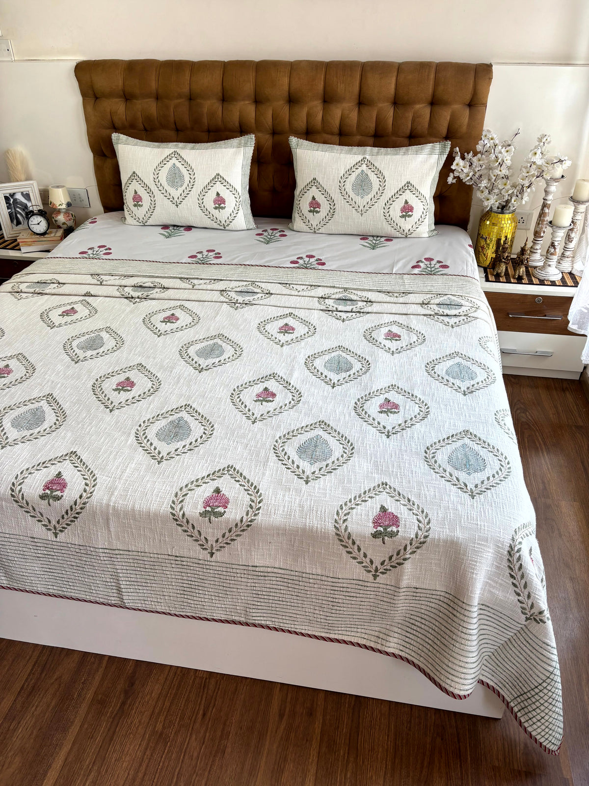 Padma Vana hand block printed king size jute cotton bedcover styled in an elegant contemporary bedroom.
