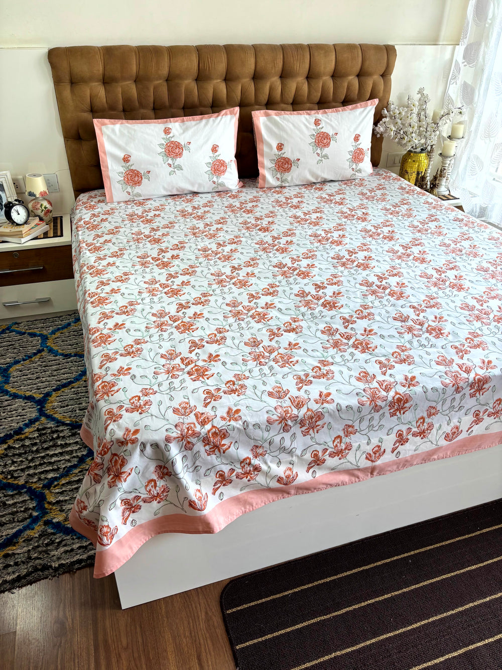 Detailed view of terracotta floral hand block printed pillow cover with contrast border and Jaipur artisan craftsmanship