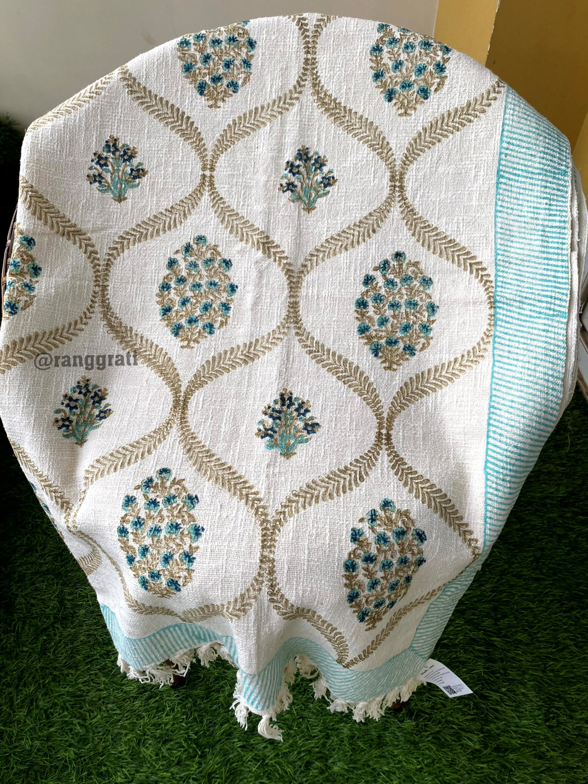 Turquoise Floral Hand Block Jute Cotton Sofa Throw - draped on a chair